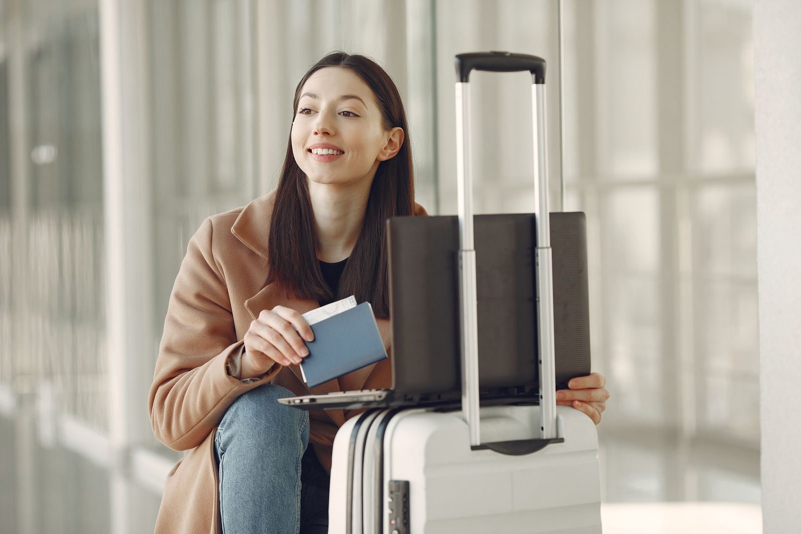 Traveler preparing Saudi visa documents with passport and laptop